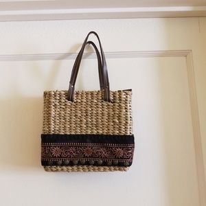 Straw bag with ribbon detail.